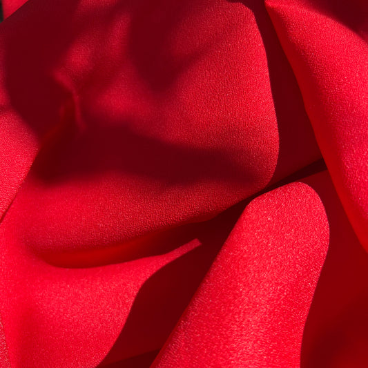 red crepe poly blend fabric (sold by yard; 3 yards avail)